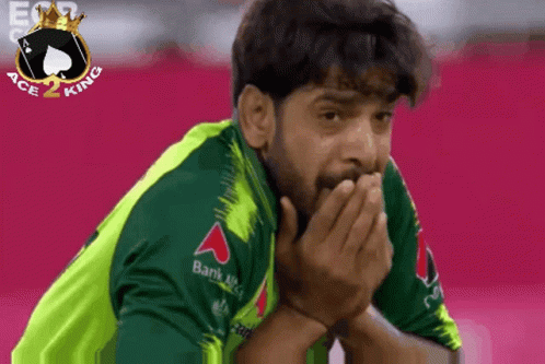 A Man Wearing A Green Shirt With A Bank Logo On The Sleeve GIF