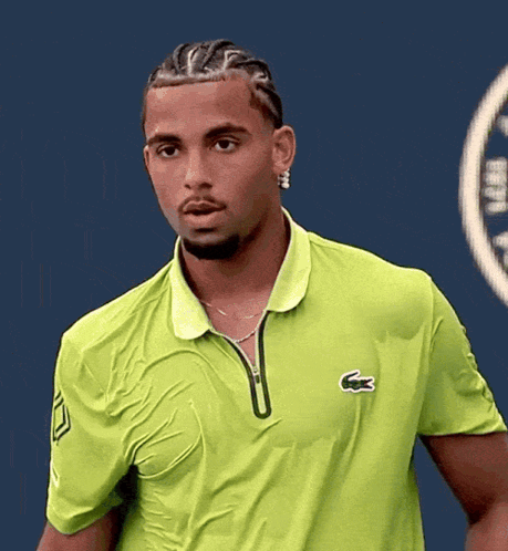A Man Wearing A Green Shirt With A Lacoste Logo On The Front GIF