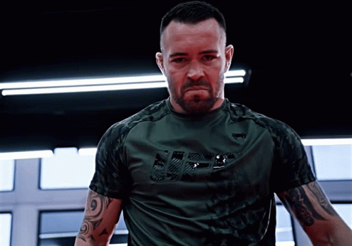 A Man Wearing A Green Shirt With The Word Ufc On It GIF