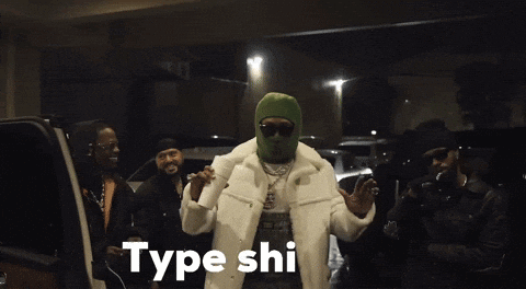 a man wearing a green ski mask is holding a cup of coffee and says type shi
