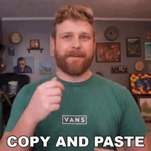 A Man Wearing A Green Vans Shirt Is Giving A Thumbs Up GIF