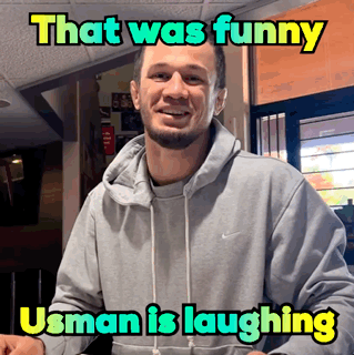 A Man Wearing A Grey Nike Hoodie Is Laughing With A Caption That Says That Was Funny Usman Is Laughing GIF