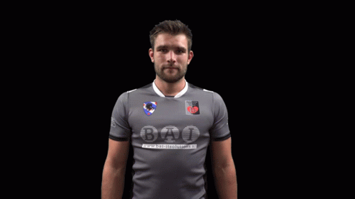 A Man Wearing A Grey Shirt That Says Bat GIF