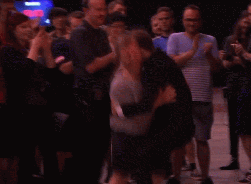 A Man Wearing A Grey Shirt That Says ' Tivoli ' On The Front GIF