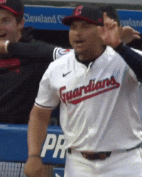 A Man Wearing A Guardians Jersey Stands In Front Of A Dugout GIF