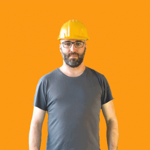 A Man Wearing A Hard Hat And Glasses Is Making A Thumbs Down Sign GIF