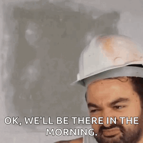 A Man Wearing A Hard Hat Is Saying Ok We 'Ll Be There In The Morning GIF