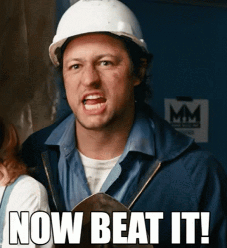 A Man Wearing A Hard Hat With The Words Now Beat It Written Below Him GIF