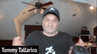 A Man Wearing A Hat And A Black Shirt Is Named Tommy Tallarico GIF