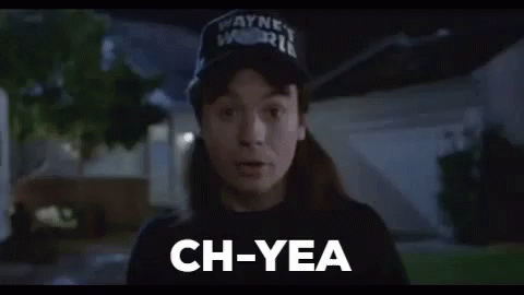 A Man Wearing A Hat And A Black Shirt Is Standing In Front Of A House And Saying `` Ch-Yea '' . GIF