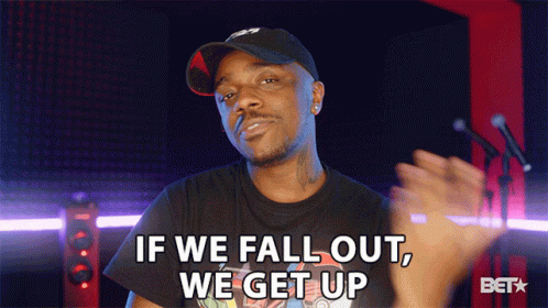 a man wearing a hat and a black shirt says if we fall out we get up