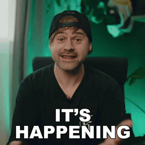 A Man Wearing A Hat And A Black Shirt Says It 'S Happening GIF