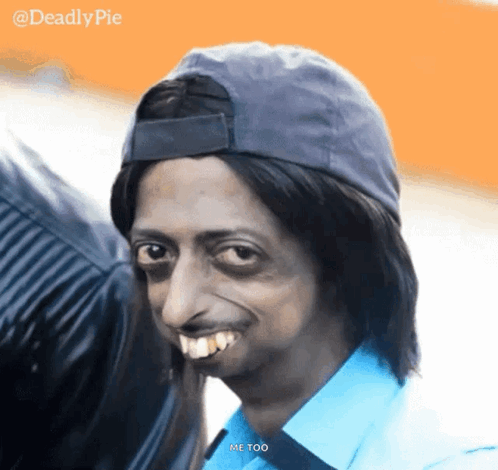 A Man Wearing A Hat And A Blue Shirt Is Smiling And Says Me Too GIF