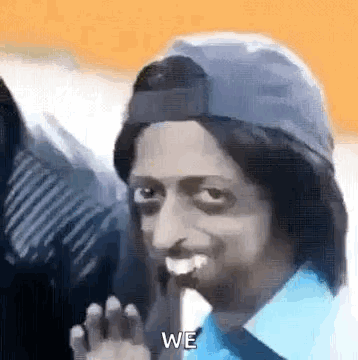 Man In Blue Shirt And Hat Waving Smiling GIF