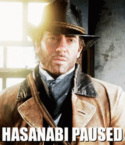 A Man Wearing A Hat And A Coat With The Words Hasanabi Paused Written Below Him GIF