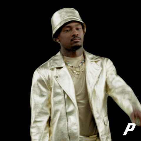 A Man Wearing A Hat And A Gold Jacket With The Letter P In The Corner GIF