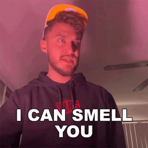A Man Wearing A Hat And A Hoodie Says " I Can Smell You " GIF