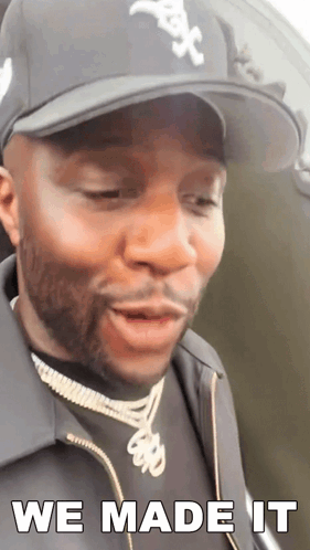 A Man Wearing A Hat And A Jacket Says We Made It GIF