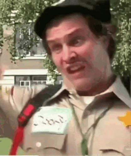 A Man Wearing A Hat And A Name Tag That Says ' Joker ' On It GIF