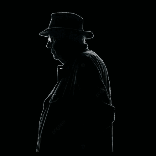 A Man Wearing A Hat And A Necklace Covering His Face With His Hand GIF
