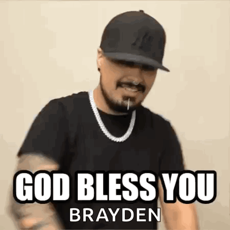 A Man Wearing A Hat And A Necklace Is Making A Funny Face And Saying `` God Bless You Brayden '' . GIF
