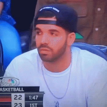 A Man Wearing A Hat And A Necklace Is Watching A Basketball Game On A Television . GIF