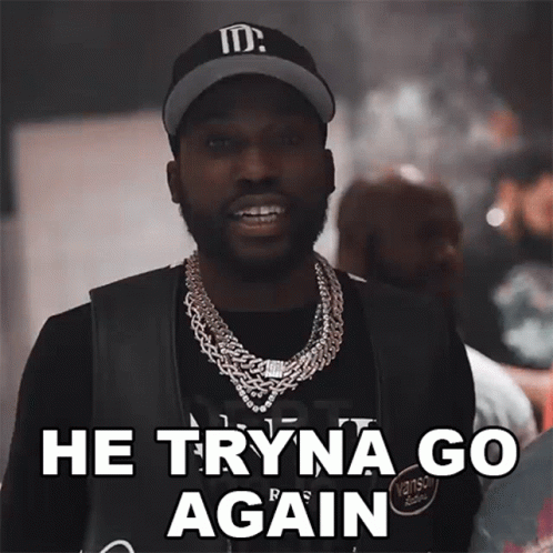 A Man Wearing A Hat And A Necklace Says " He Tryna Go Again " GIF