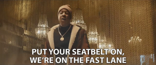 A Man Wearing A Hat And A Necklace Says Put Your Seatbelt On We 'Re On The Fast Lane GIF