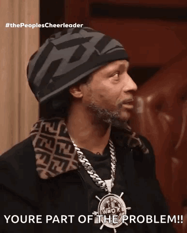 A Man Wearing A Hat And A Necklace Says Youre Part Of The Problem ! GIF