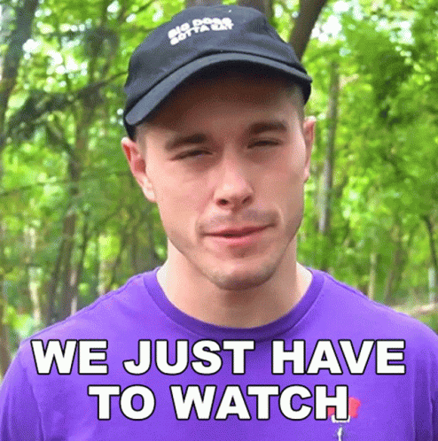 A Man Wearing A Hat And A Purple Shirt Says " We Just Have To Watch " GIF