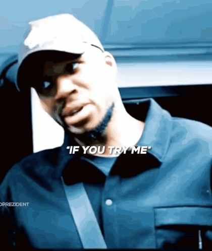 a man wearing a hat and a shirt says " if you try me "