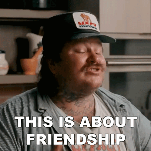 A Man Wearing A Hat And A Shirt That Says This Is About Friendship GIF