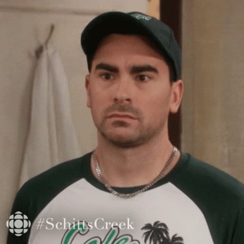 A Man Wearing A Hat And A Shirt With The Word Schitts Creek On It GIF