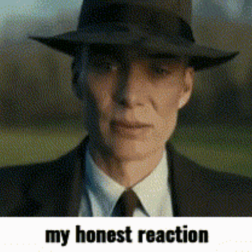 A Man Wearing A Hat And A Suit With The Words My Honest Reaction Below Him GIF
