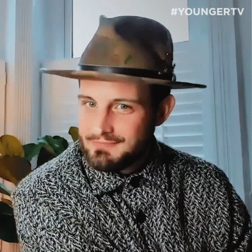 A Man Wearing A Hat And A Sweater With The Hashtag Youngertv On The Bottom Right GIF