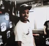 A Man Wearing A Hat And A T-Shirt That Says " Black " On It GIF