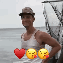 A Man Wearing A Hat And A Tank Top Is Standing In Front Of A Fishing Net With Two Smiley Faces . GIF