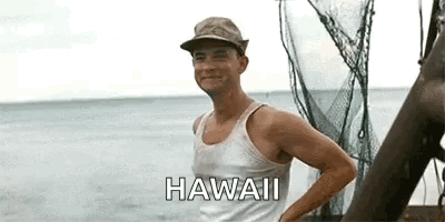 A Man Wearing A Hat And A Tank Top Is Standing On A Boat Near The Ocean . GIF