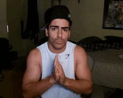 A Man Wearing A Hat And A Tank Top That Says Gymshark GIF