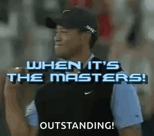 A Man Wearing A Hat And A Vest Is Standing In Front Of A Crowd And Holding A Microphone . GIF