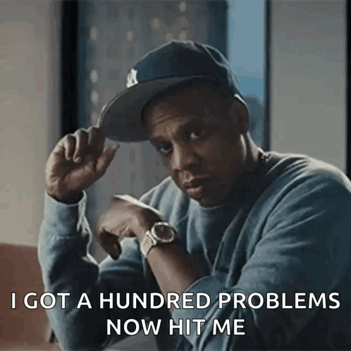 A Man Wearing A Hat And A Watch Is Saying I Got A Hundred Problems Now Hit Me GIF