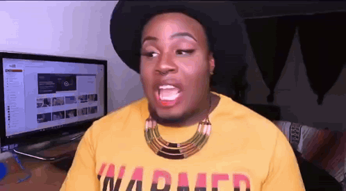 a man wearing a hat and a yellow shirt with the word warped on it .