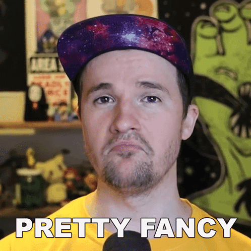 A Man Wearing A Hat And A Yellow Shirt With The Words Pretty Fancy Below Him GIF