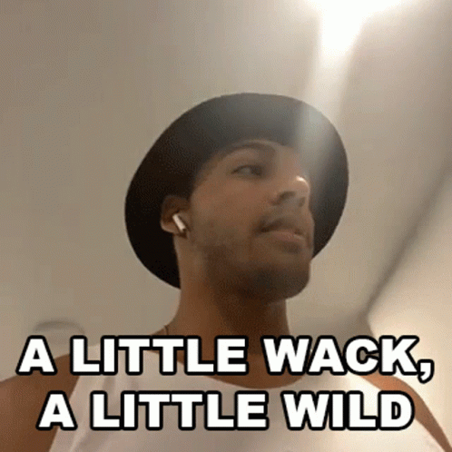 A Man Wearing A Hat And Earbuds Says A Little Wack A Little Wild GIF