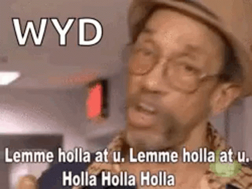 A Man Wearing A Hat And Glasses Is Making A Funny Face While Talking . GIF