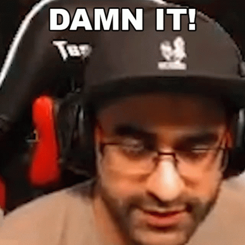 A Man Wearing A Hat And Glasses Is Sitting In A Chair And Says `` Damn It ! '' GIF