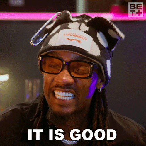 A Man Wearing A Hat And Glasses Is Smiling And Says It Is Good GIF