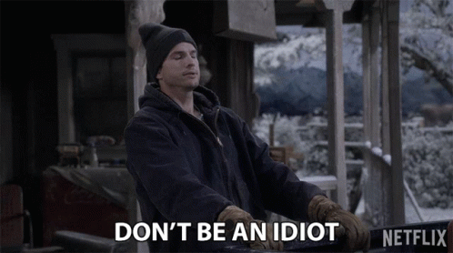 A Man Wearing A Hat And Gloves Says " Don 'T Be An Idiot " GIF