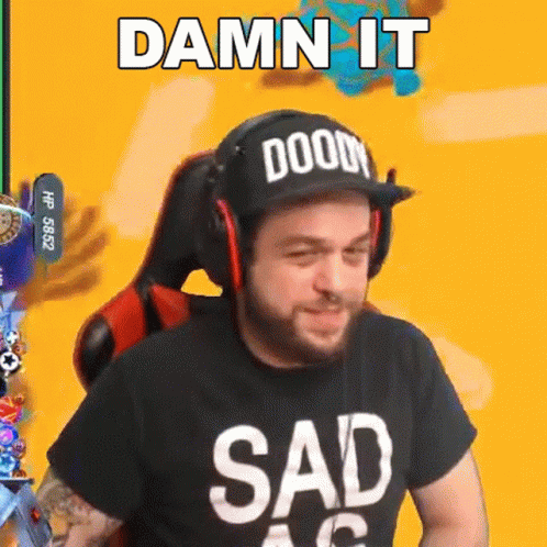 A Man Wearing A Hat And Headphones Is Sitting In A Chair And Making A Sad Face . GIF