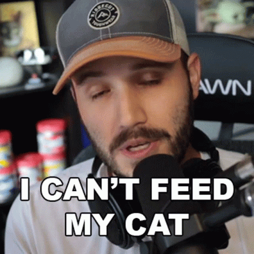 A Man Wearing A Hat And Headphones Says I Can T Feed My Cat GIF